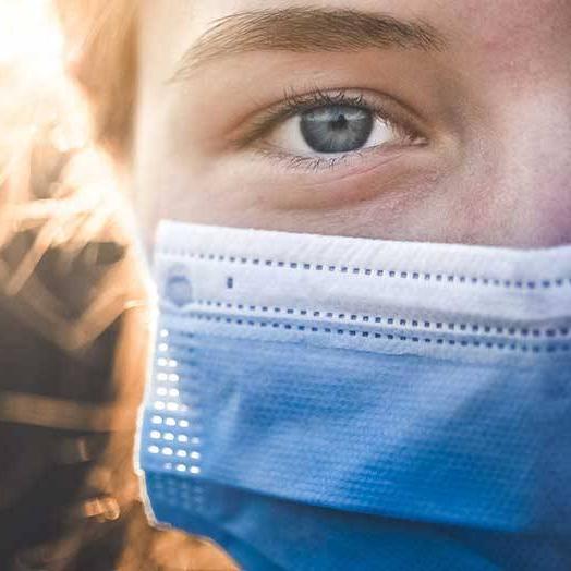 person wearing facemask with blurred background